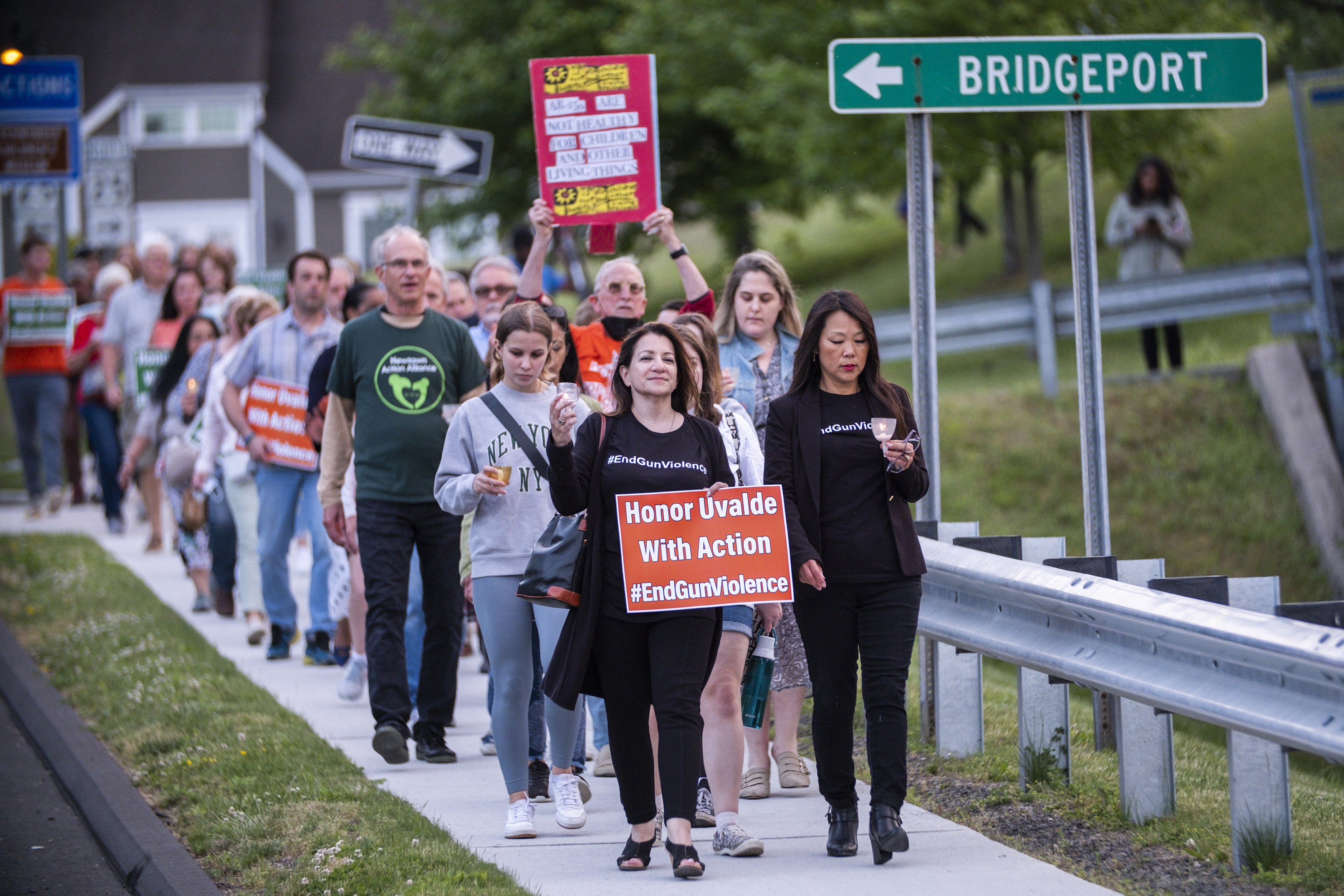 People march along a local street at the end of a vigil to stand in solidarity with the Uvalde, Texas, families and demand an end to gun violence on Thursday, May 26, 2022, in Newtown, Conn.